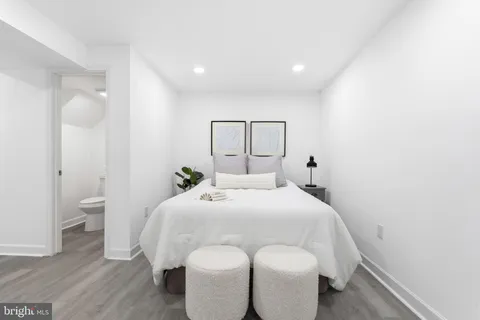 a bedroom with a bed and a mirror