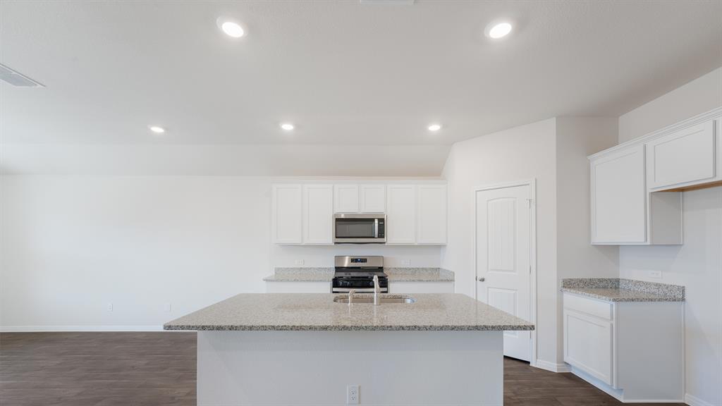 14021 Feinstein Street Manor, TX 78653 - Photo 7 of 25 A pristine culinary space awaits, featuring sparkling counters and modern appliances.