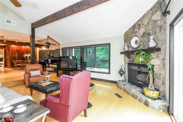 a living room with fireplace furniture and a floor to ceiling window