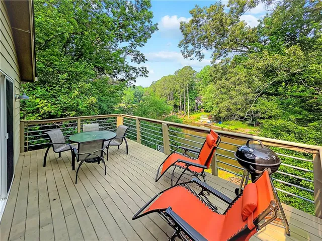 an outdoor sitting area with furniture and wooden floor