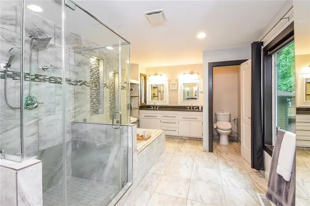 a bathroom with a tub shower and sink