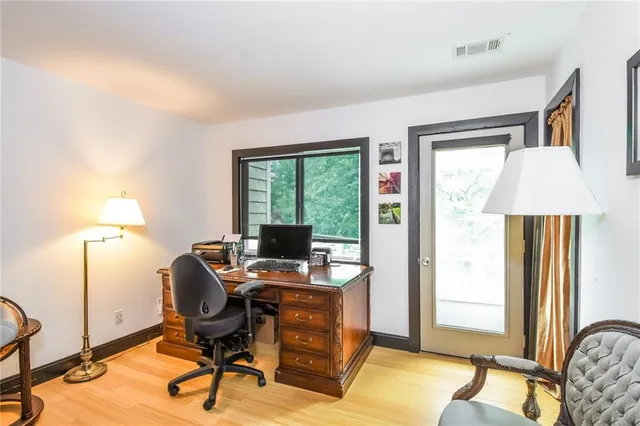 a view of a workspace with furniture and a window
