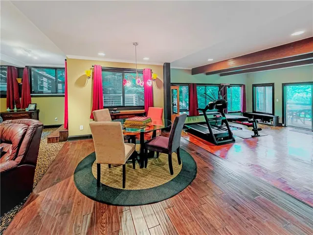 a dining room with furniture and wooden floor