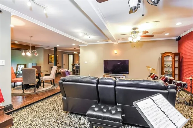 a living room with furniture a rug and a flat screen tv