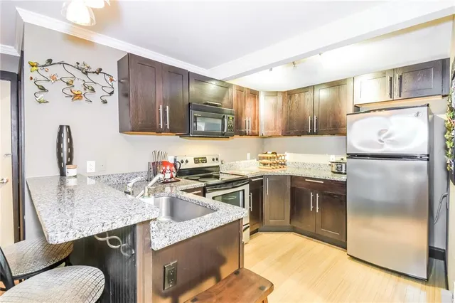 a kitchen with a sink appliances and cabinets