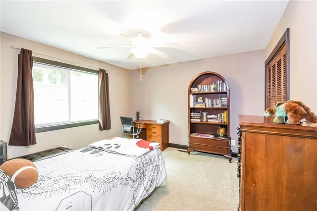 a bedroom with a bed and furniture with outer view