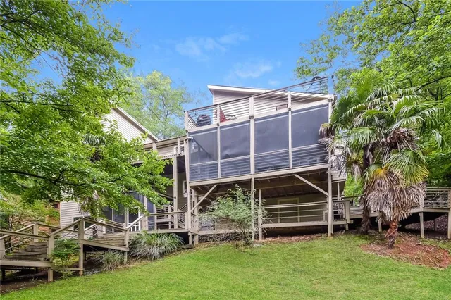 a view of house with a yard and sitting area