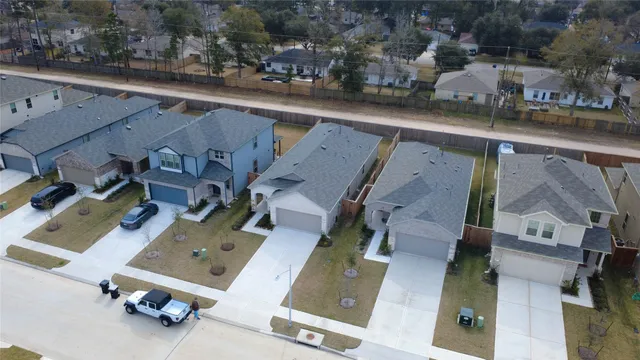 an aerial view of residential houses with outdoor space