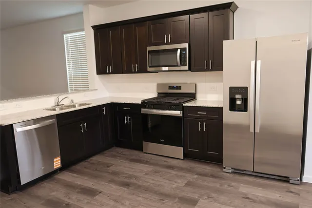 a kitchen with a sink stove and refrigerator