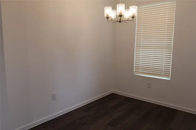 an empty room with wooden floor