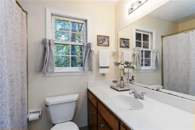 a bathroom with a toilet sink and mirror