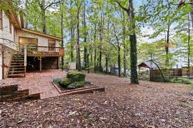 a view of a house with a yard and tree s