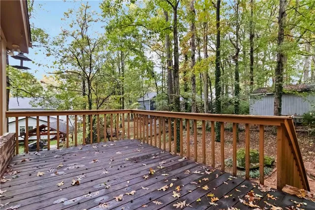 a balcony with wooden floor and outdoor space
