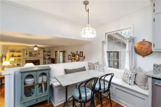 a view of a dining room with furniture and chandelier