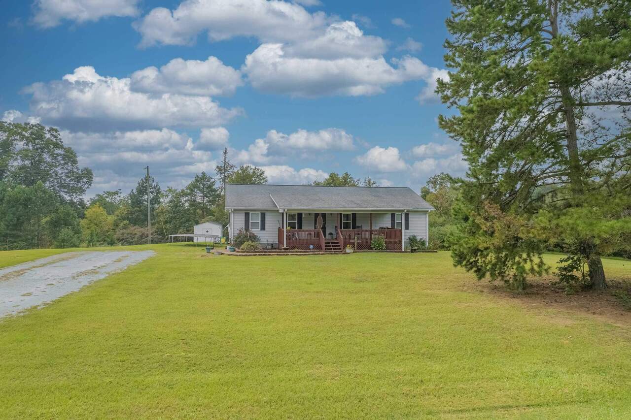 1841 Hunters Creek Road Carnesville, GA 30521 - Photo 1 of 1 a view of a house with a big yard and large trees