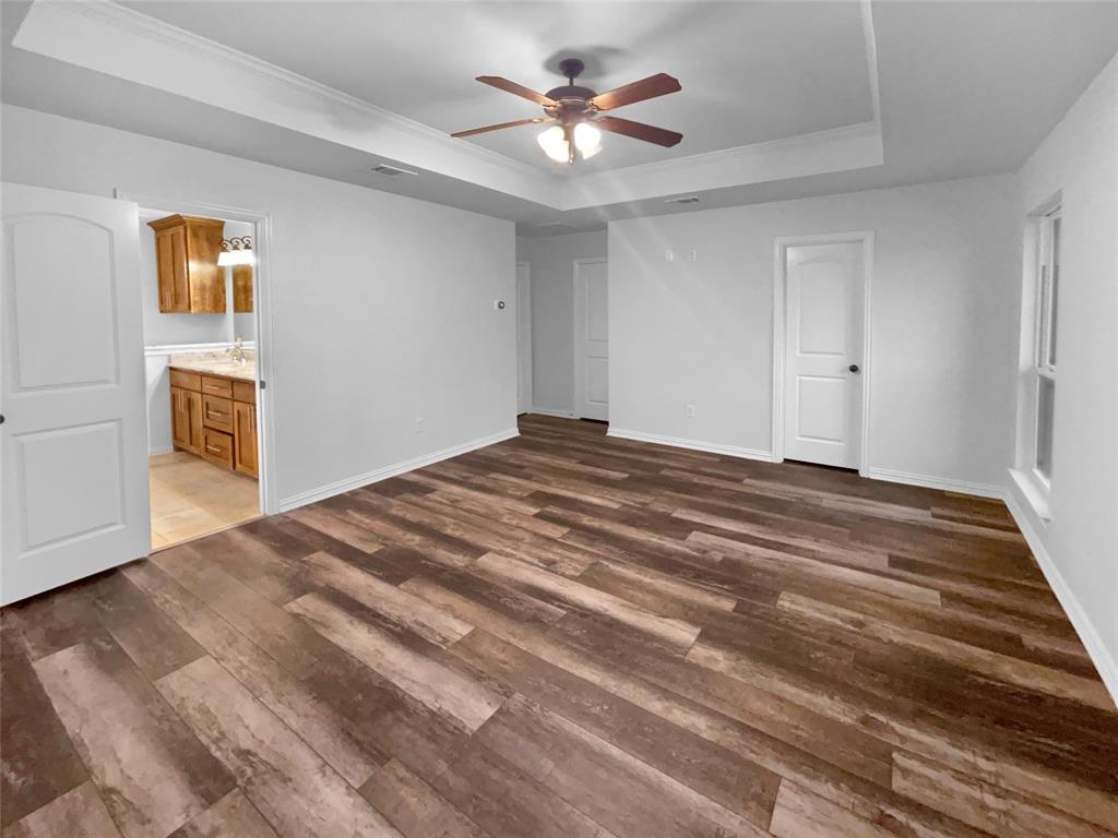 3915 Tower Circle Nevada, TX 75173 - Photo 14 of 29 a bedroom with a bed and a chandelier fan