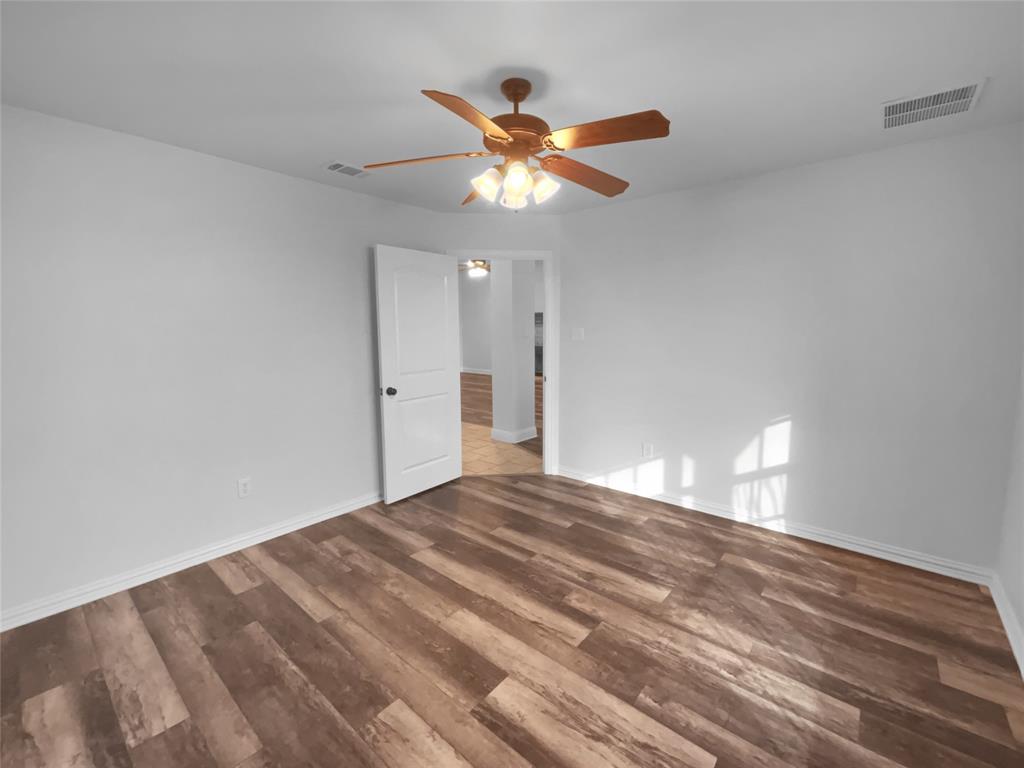 3915 Tower Circle Nevada, TX 75173 - Photo 17 of 29 a view of empty room with wooden floor and fan
