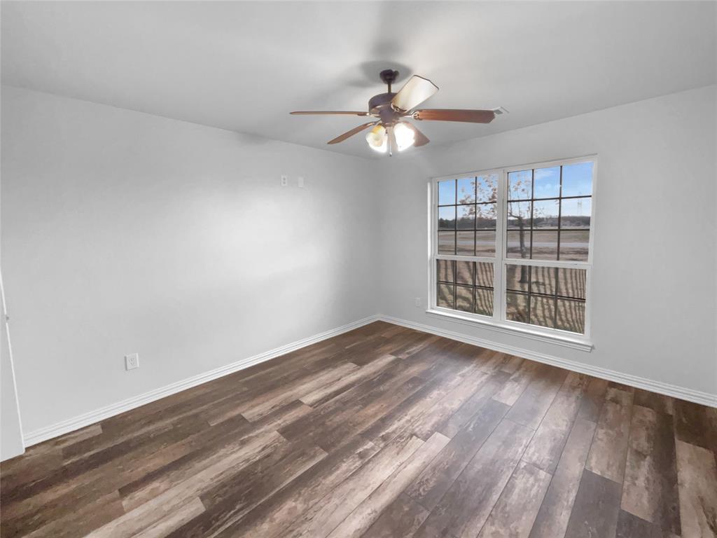 3915 Tower Circle Nevada, TX 75173 - Photo 19 of 29 a view of an empty room with wooden floor and a window