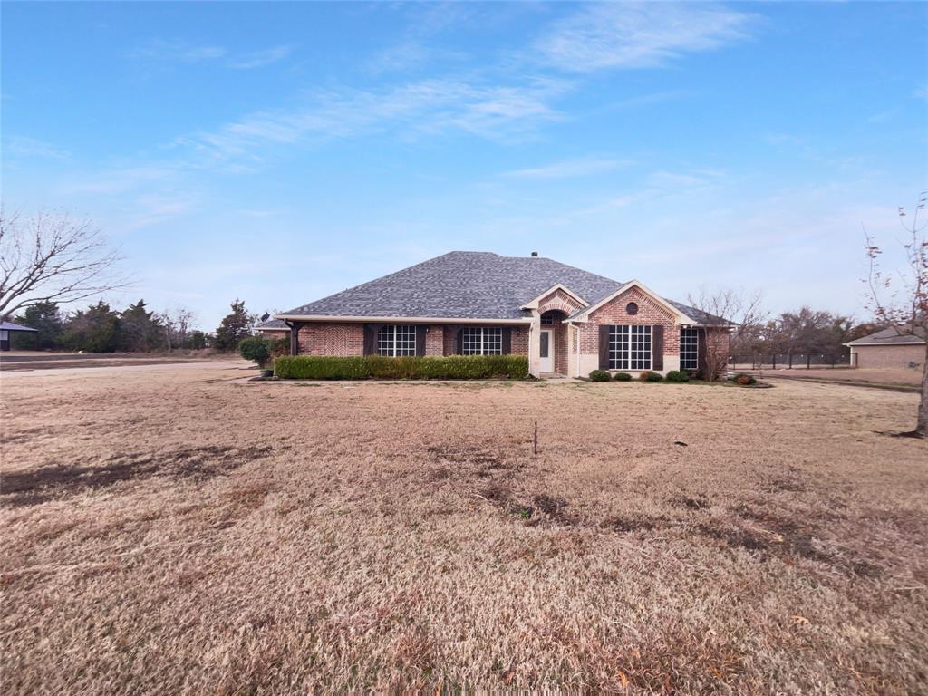 3915 Tower Circle Nevada, TX 75173 - Photo 2 of 29 a front view of a house with a yard