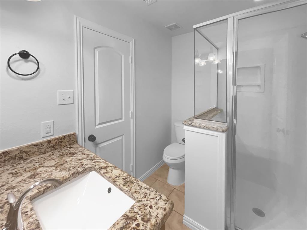 3915 Tower Circle Nevada, TX 75173 - Photo 21 of 29 a bathroom with a granite countertop sink toilet and shower