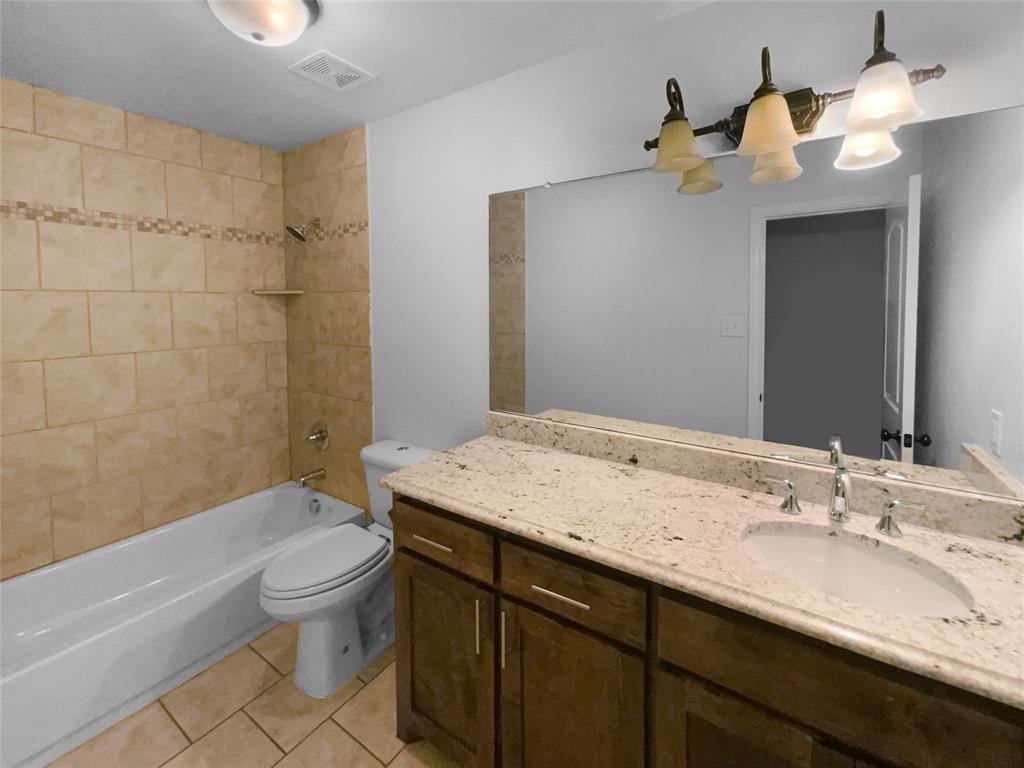 3915 Tower Circle Nevada, TX 75173 - Photo 24 of 29 a bathroom with a sink a toilet and shower
