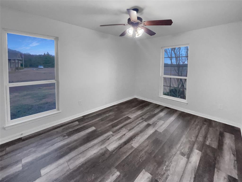 3915 Tower Circle Nevada, TX 75173 - Photo 26 of 29 a view of empty room with wooden floor and fan