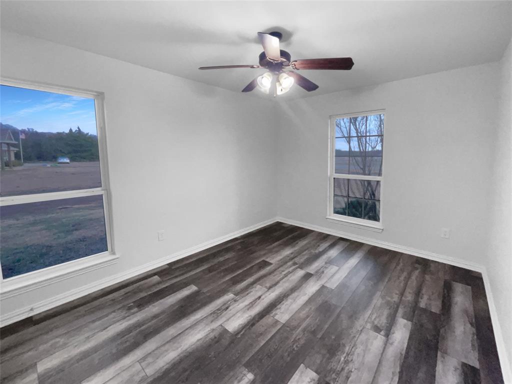 3915 Tower Circle Nevada, TX 75173 - Photo 27 of 29 a view of an empty room with wooden floor and a window