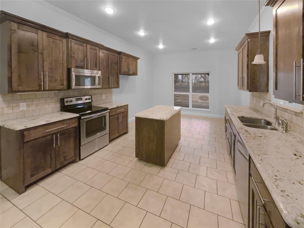 3915 Tower Circle Nevada, TX 75173 - Photo 6 of 29 a kitchen with stainless steel appliances granite countertop a sink stove and refrigerator