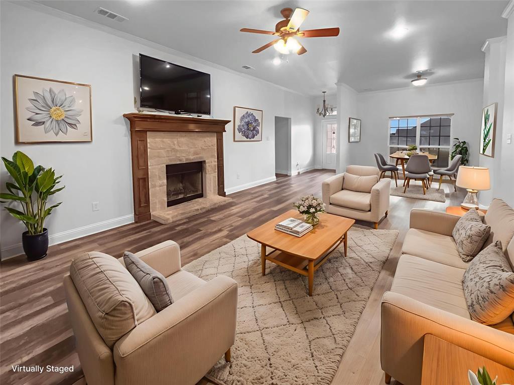 3915 Tower Circle Nevada, TX 75173 - Photo 8 of 29 a living room with furniture a flat screen tv and a fireplace