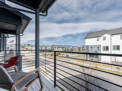 a view of a balcony with furniture and city view