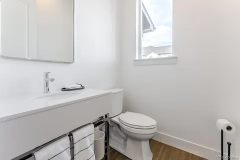 a bathroom with a sink a toilet and mirror