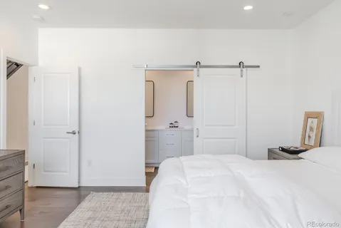 a bedroom with a bed and a mirror