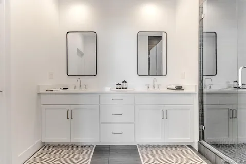 a bathroom with double vanity sink two mirror and a