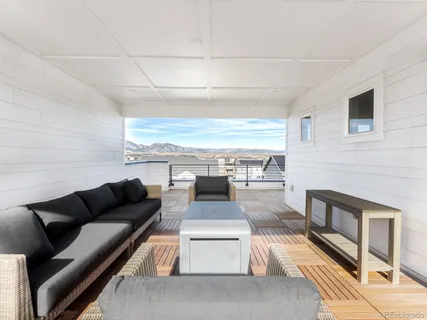 a view of balcony with wooden floor and seating space