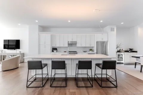 a kitchen with stainless steel appliances kitchen island granite countertop a sink and a stove