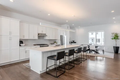 a kitchen with lots of wooden furniture and white appliances