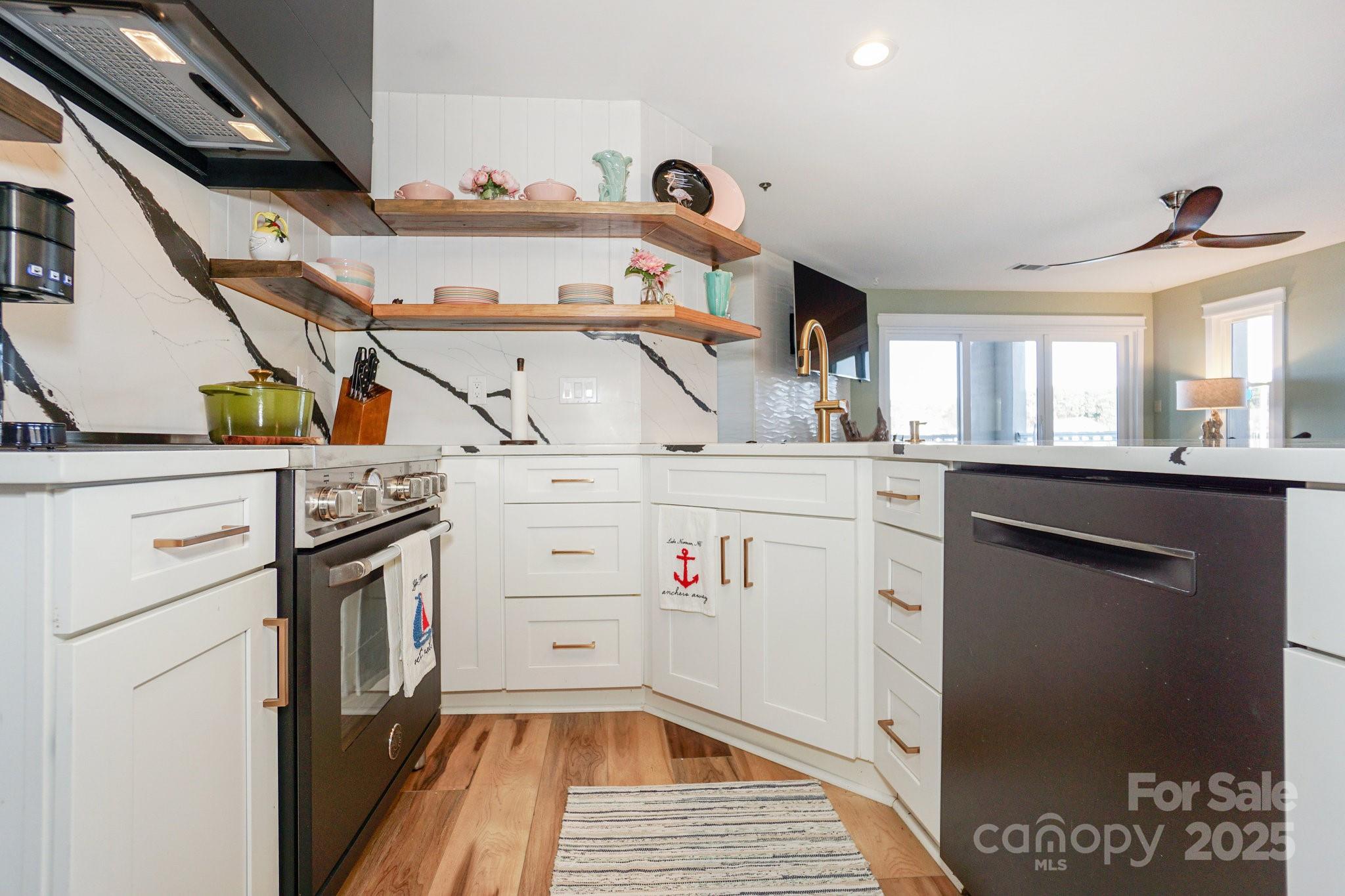 18631 Vineyard Point Lane Cornelius, NC 28031 - Photo 14 of 43 a kitchen with a sink stove and cabinets
