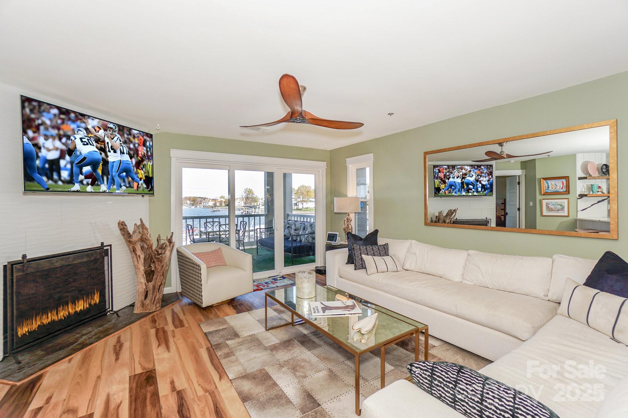 18631 Vineyard Point Lane Cornelius, NC 28031 - Photo 16 of 43 a living room with furniture a rug and a fireplace