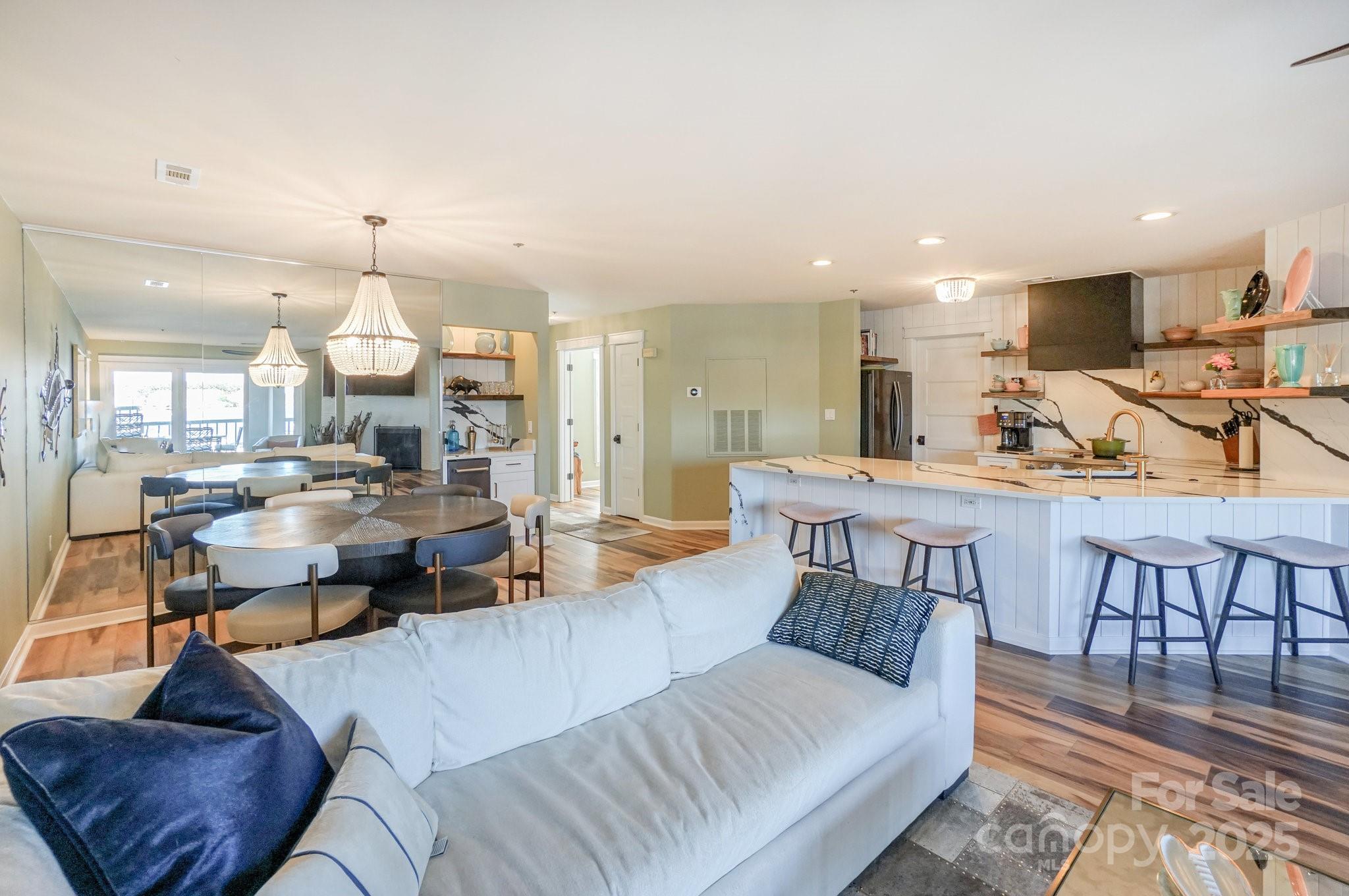 18631 Vineyard Point Lane Cornelius, NC 28031 - Photo 17 of 43 a living room with furniture a rug and kitchen view
