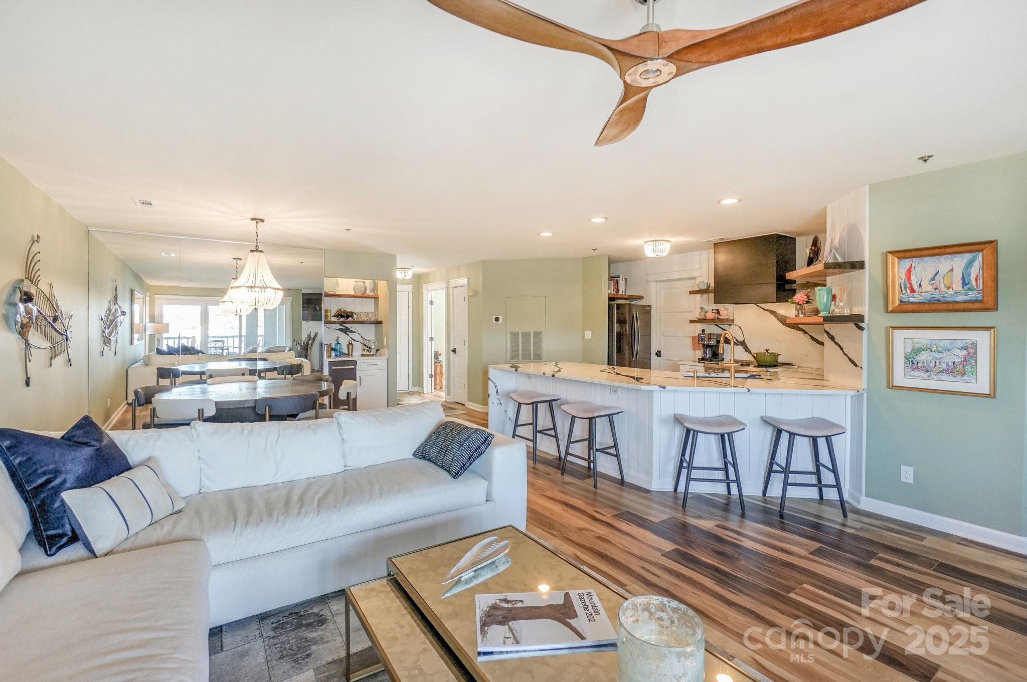 18631 Vineyard Point Lane Cornelius, NC 28031 - Photo 18 of 43 a living room with lots of furniture and kitchen view