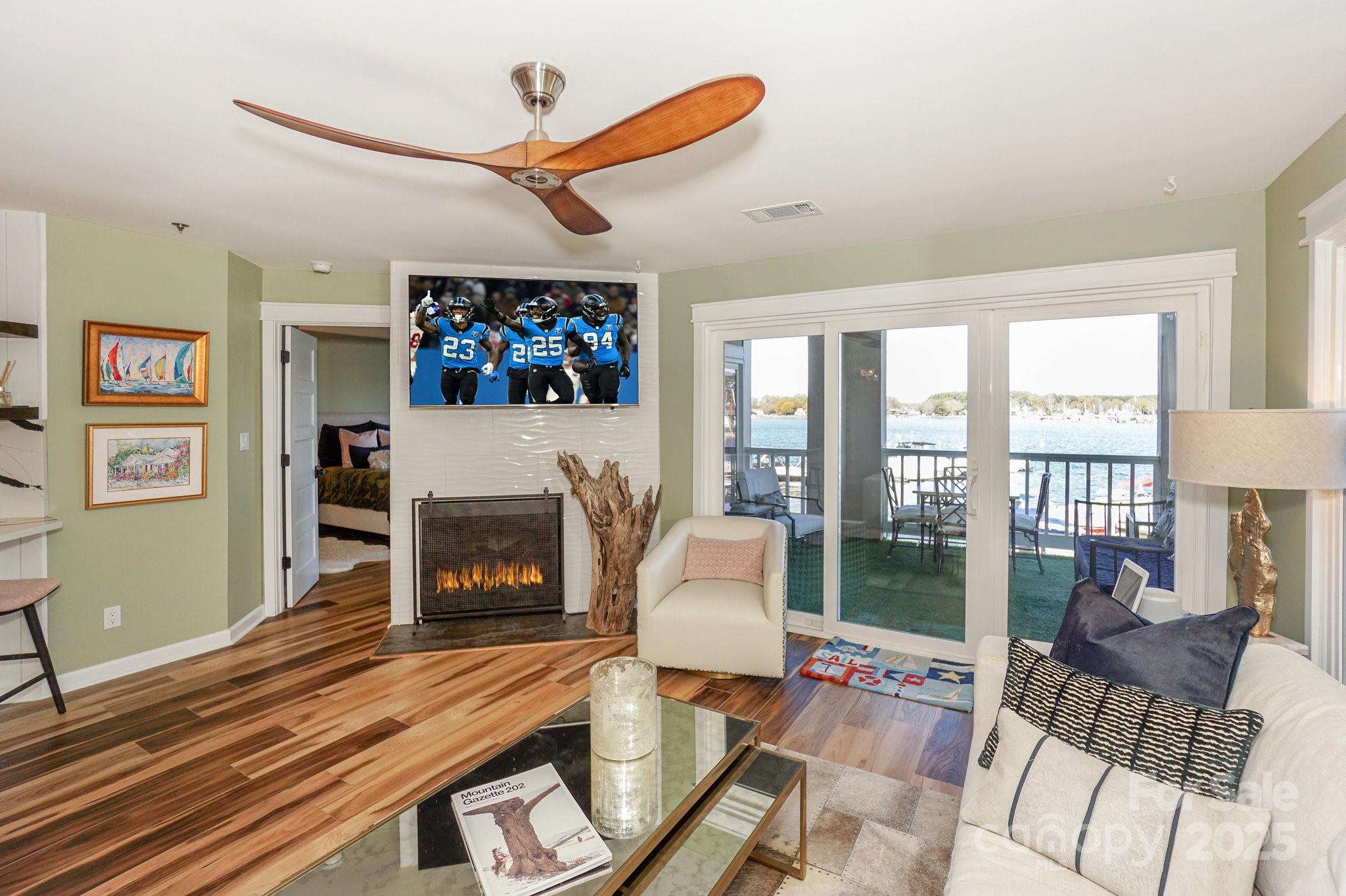18631 Vineyard Point Lane Cornelius, NC 28031 - Photo 4 of 43 a living room with furniture a fireplace and a flat screen tv