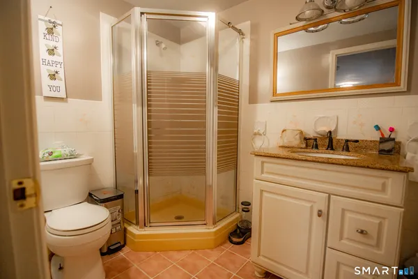 a bathroom with a toilet sink and shower