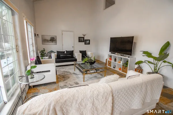 a living room with furniture and a flat screen tv