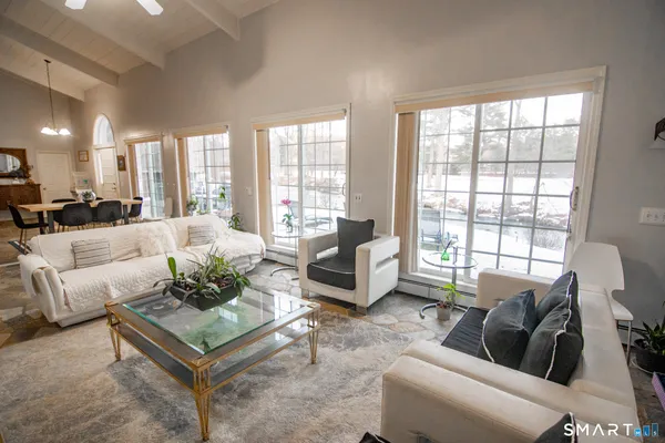 a living room with furniture and a large window