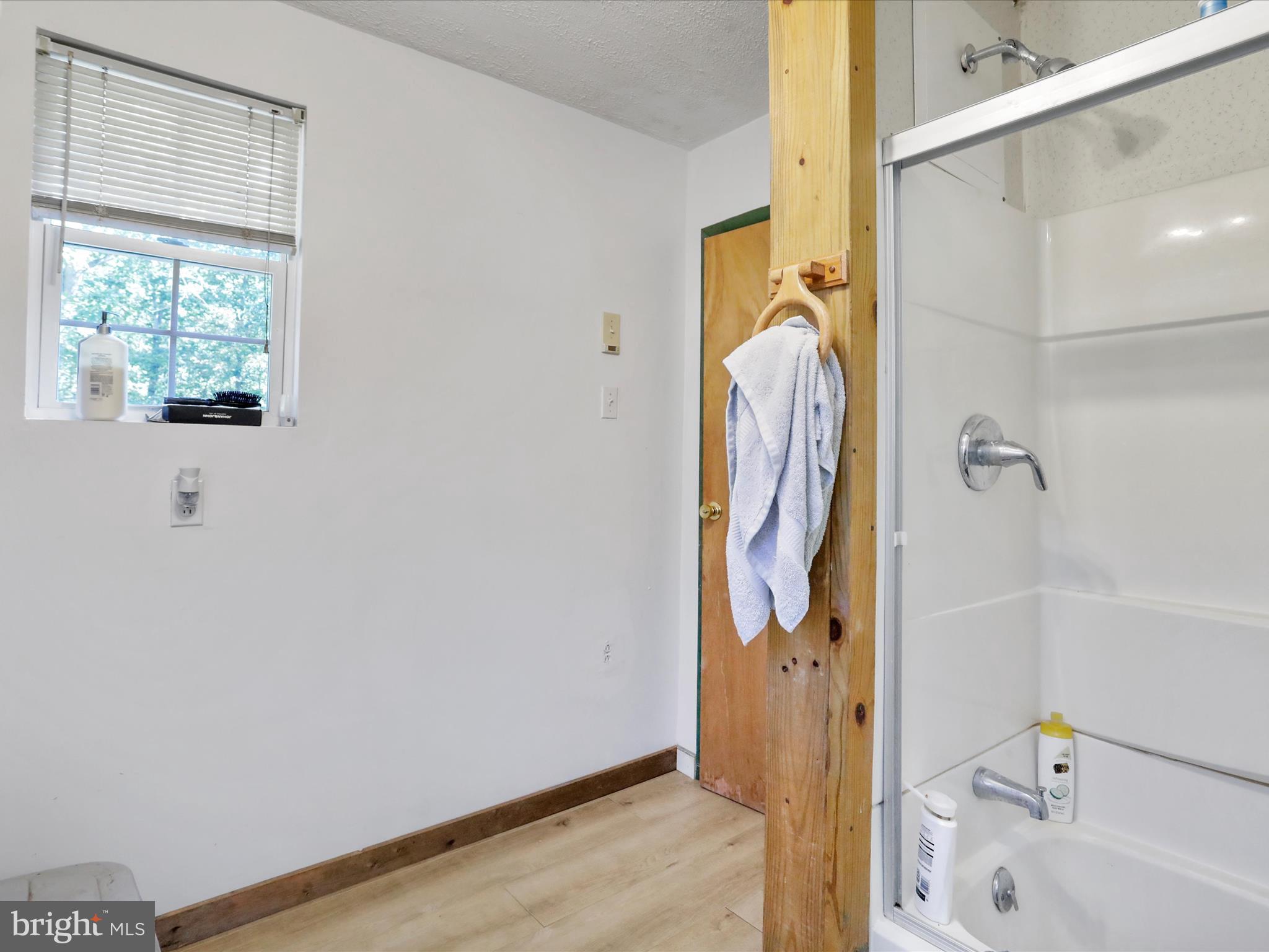 2370 Kerns School Road Springfield, WV 26763 - Photo 24 of 45 a bathroom with a tub and shower