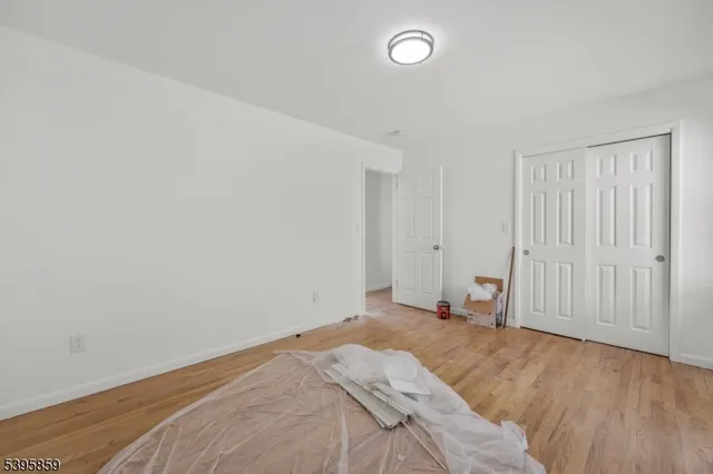 an empty room with wooden floor