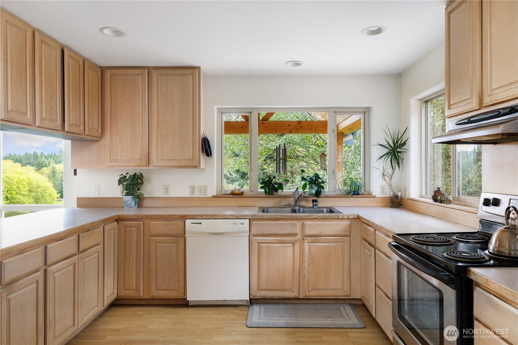 5474 Wilkinson Road Langley, WA 98260 - Photo 12 of 40 a kitchen with a sink stove and cabinets