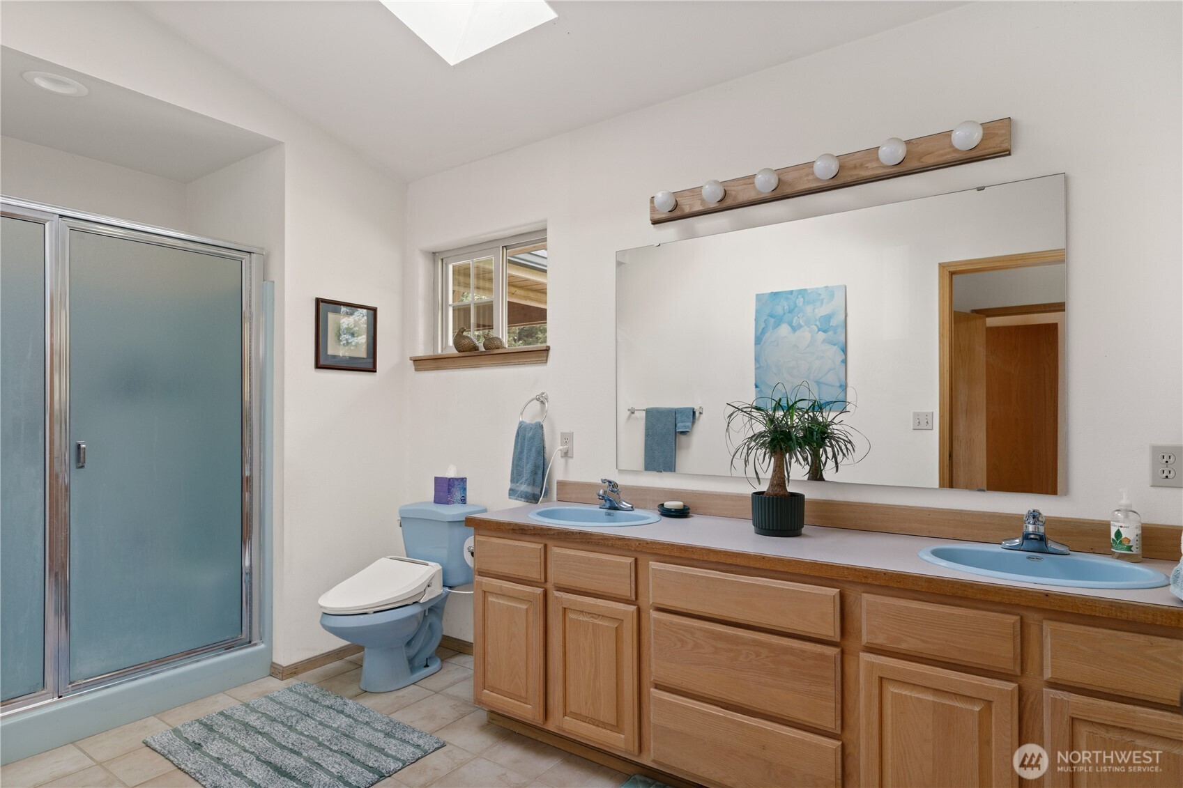 5474 Wilkinson Road Langley, WA 98260 - Photo 14 of 40 a bathroom with a granite countertop sink mirror vanity and toilet