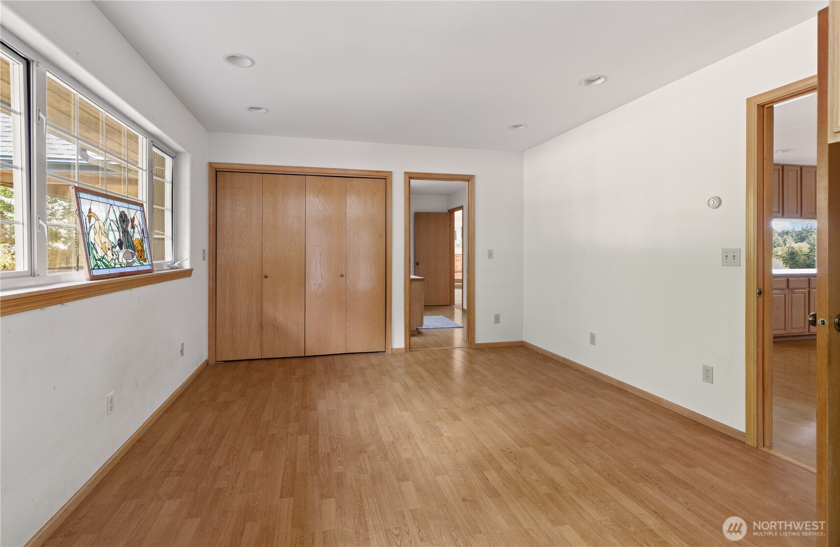 5474 Wilkinson Road Langley, WA 98260 - Photo 18 of 40 an empty room with wooden floor and windows