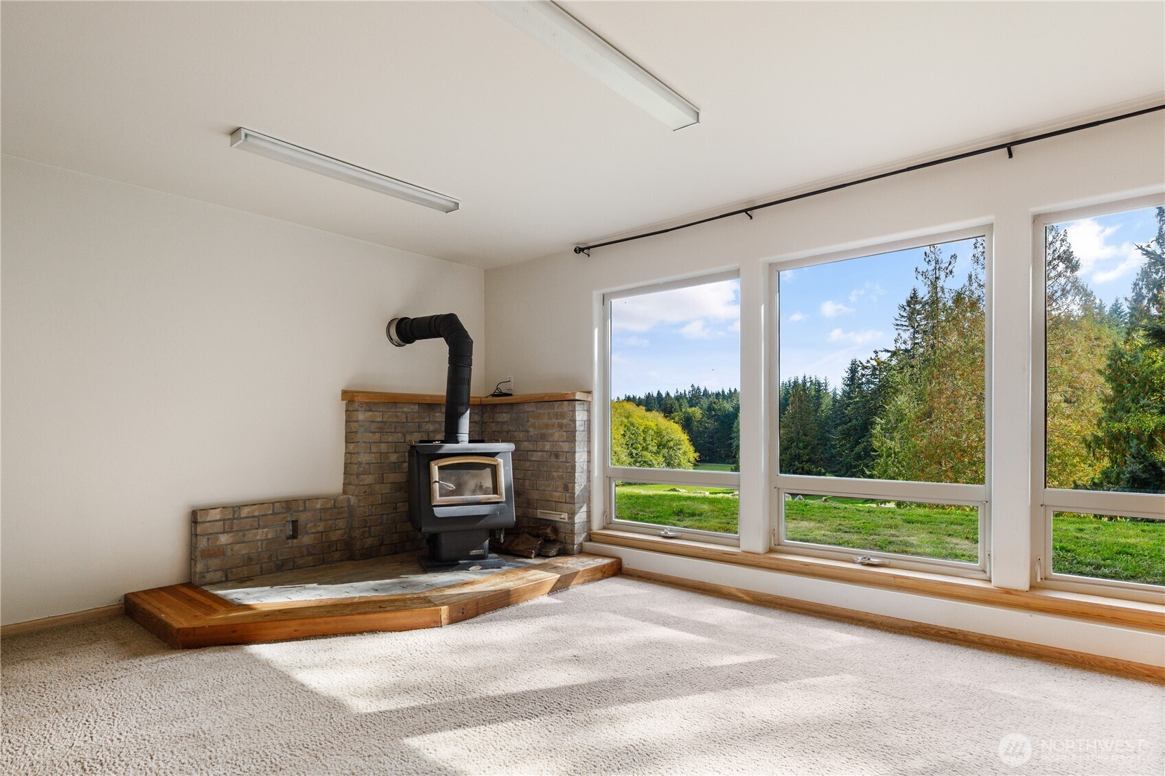 5474 Wilkinson Road Langley, WA 98260 - Photo 22 of 40 a view of a room with gym equipment and a fireplace